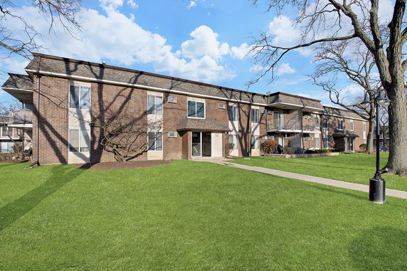 Front view of a two-story brick apartment building.