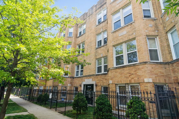Front view of a multi-story brick apartment building.