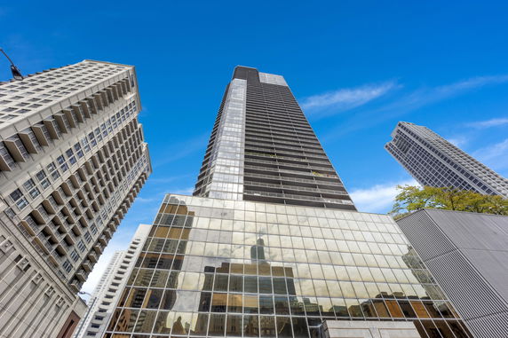 Front view of multiple high-rise buildings with glass facade and balconies.