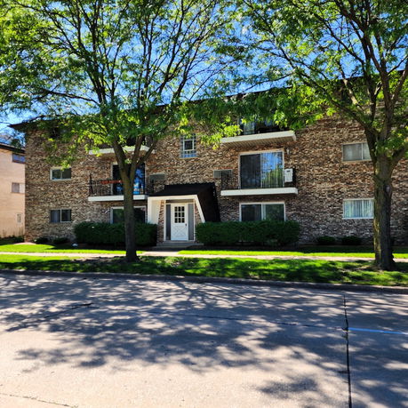 Front view of a multi-story brick apartment building.