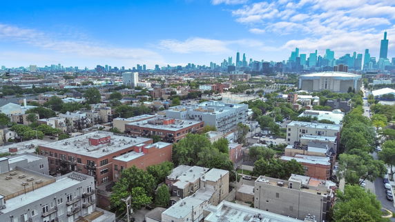 Panoramic view of a cityscape with various buildings and skyline.