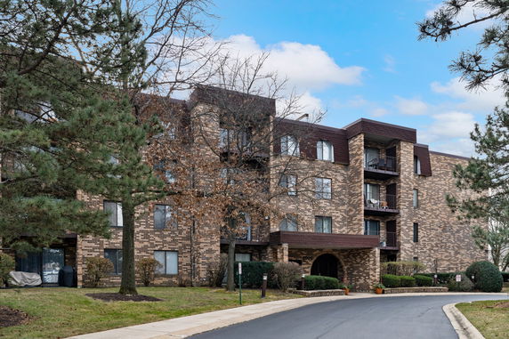 Front view of a multi-story brick apartment building.