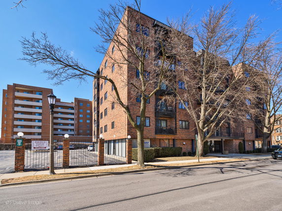 Front view of a multi-story brick apartment building.