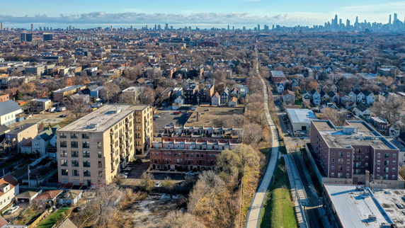 Aerial panoramic view of a residential area with city skyline in the background.