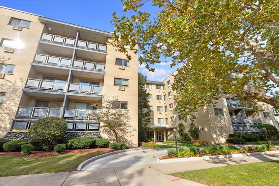 Front view of a multi-story residential building with balconies.