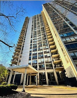 Front view of a tall multi-story building with balconies.