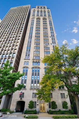 Front view of a tall, multi-story building with intricate architectural details.
