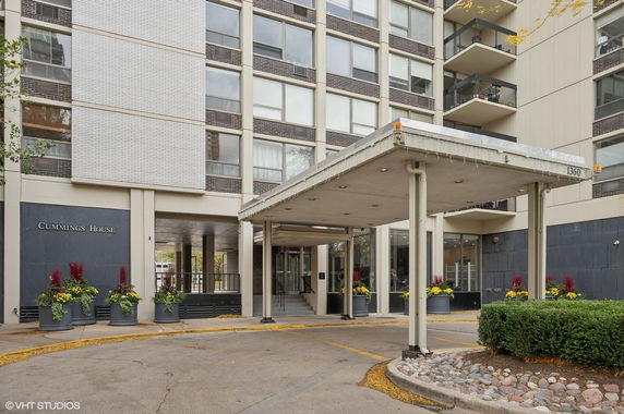 Front view of a multi-story building with a covered entrance.