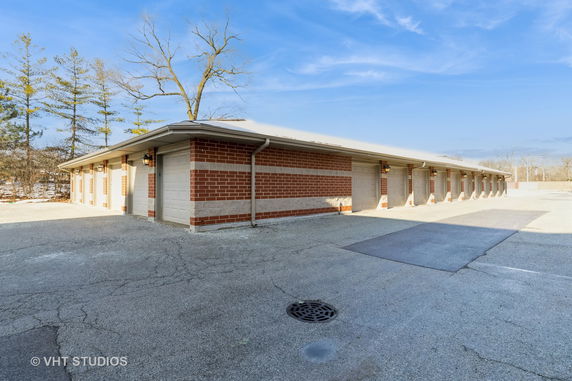Front view of a long, single-story building with brick and concrete exterior.