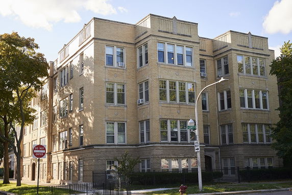 Front view of a multi-story brick apartment building.