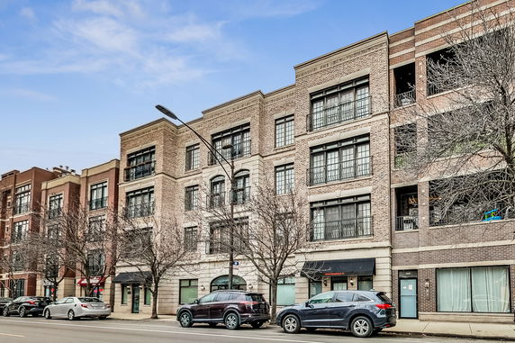 Front view of a multi-story brick apartment building.