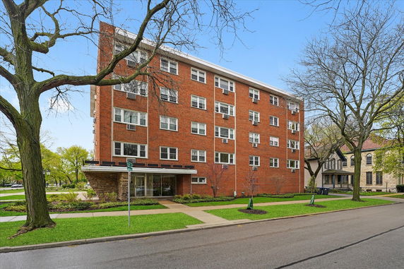 Front view of a multi-story brick apartment building.