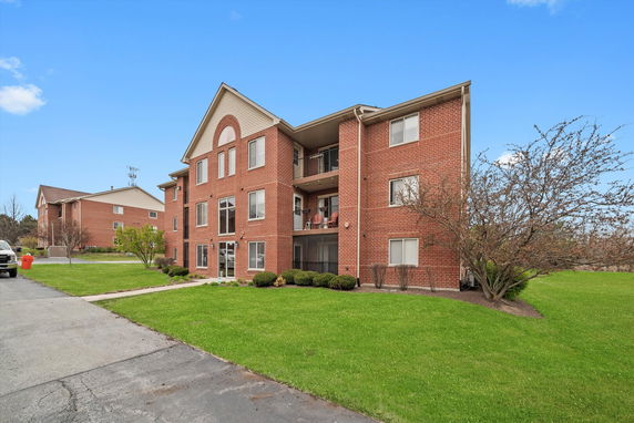 Front view of a three-story brick apartment building.