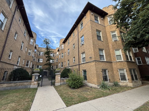 Front view of a multi-story brick apartment building.