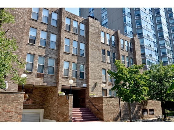 Front view of a multi-story brick apartment building.