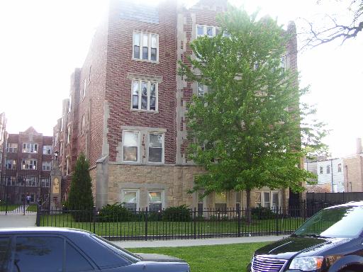 Front view of a multi-story brick apartment building.