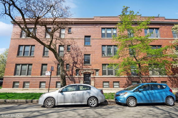 Front view of a multi-story brick apartment building.