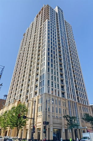 View of a tall multi-story building with modern architecture.