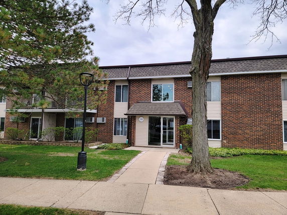 Front view of a two-story brick apartment building.