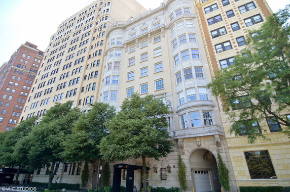 Front view of a multi-story residential building with ornate architectural details.