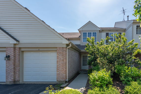 Front view of a two-story house with an attached garage.
