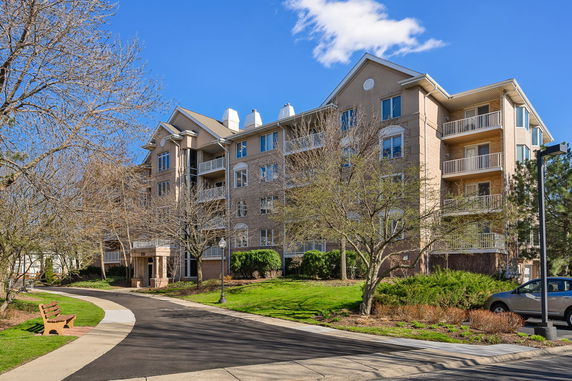 Front view of a multi-story apartment building with balconies.