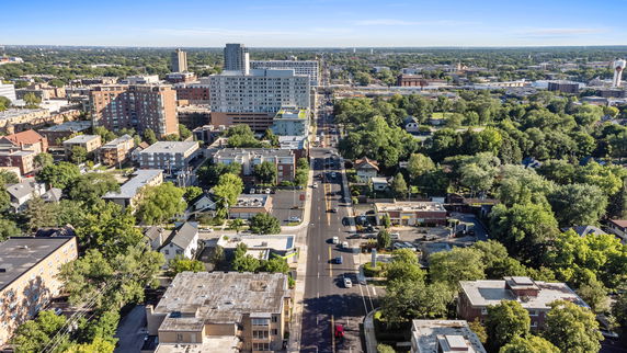 Panoramic view of a cityscape with roads and buildings.