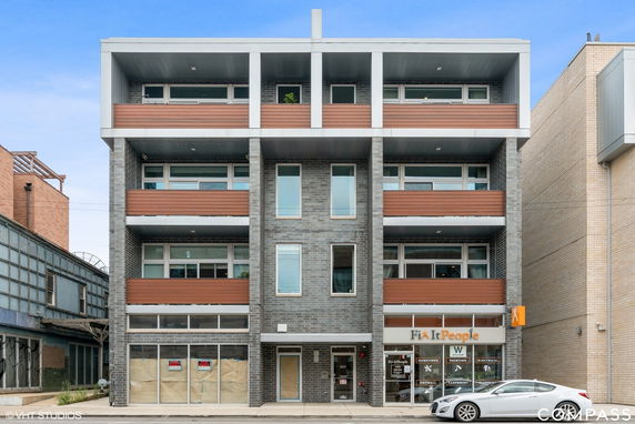 Front view of a multi-story commercial building with multiple balconies.