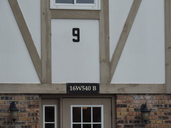 Front view of a building with a decorative facade and a number 9 displayed.