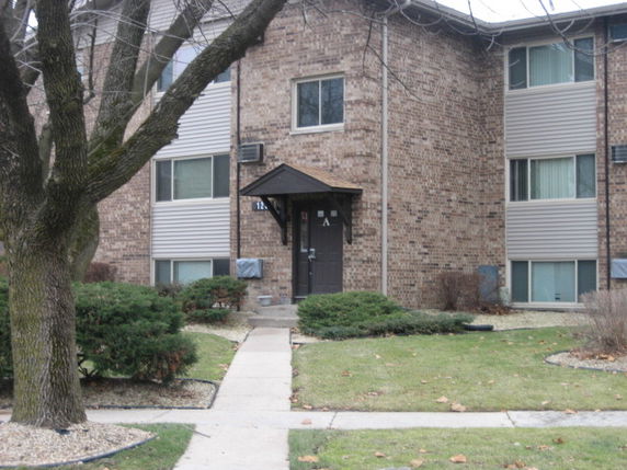 Front view of a multi-story brick apartment building.