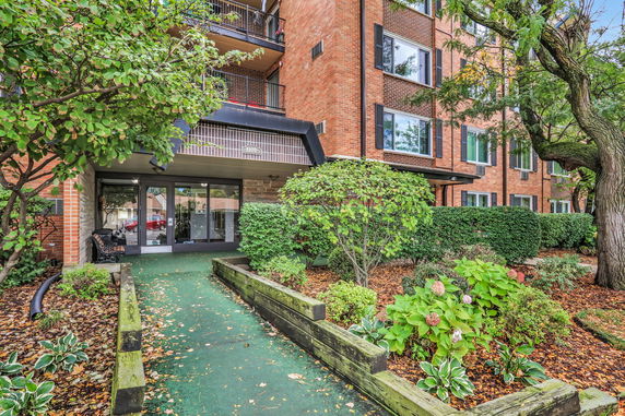 Front view of a multi-story brick building with balconies.