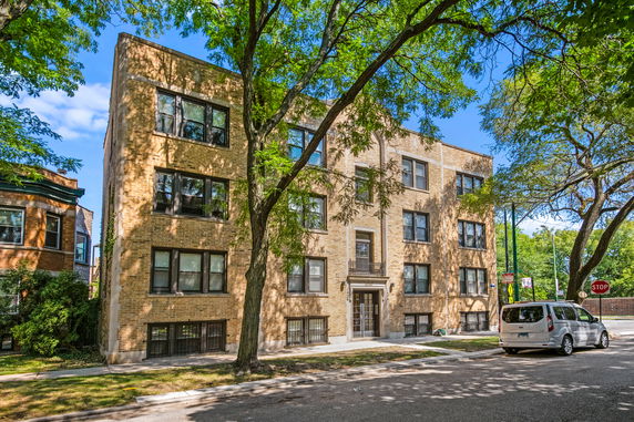Front view of a multi-story brick apartment building.