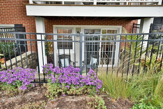 Front view of a building with brick walls and a small outdoor seating area.