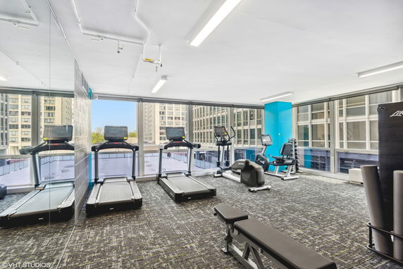 Interior view of a gym with treadmills and exercise equipment.