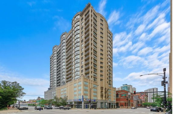 Front view of a high-rise building with a multi-story structure.