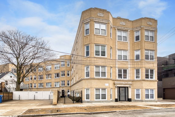 Front view of a multi-story brick apartment building.