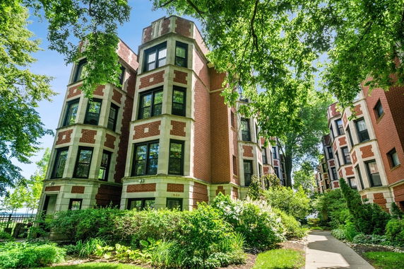 Front view of a multi-story brick apartment building complex.