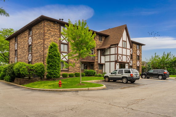 Front view of a multi-story brick building with Tudor-style elements.