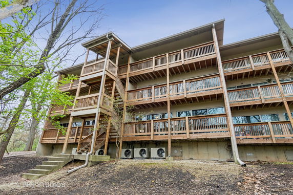 Rear view of a multi-story building with wooden balconies.