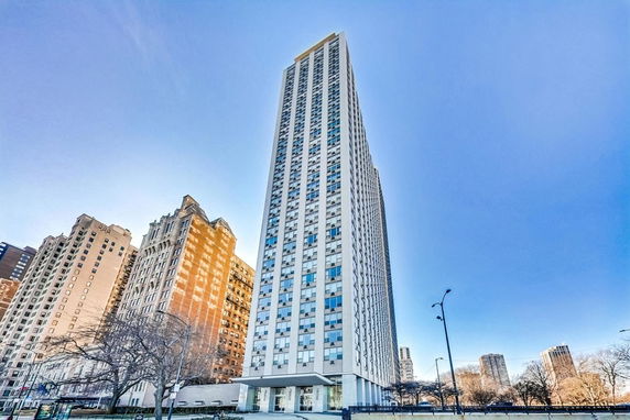 Front view of a tall high-rise building with a modern design.