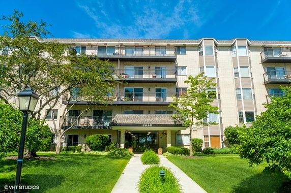 Front view of a multi-story residential building with balconies.