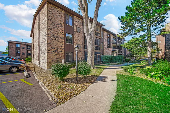 Front view of a multi-story brick apartment building.