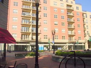 Front view of a multi-story apartment building with balconies.