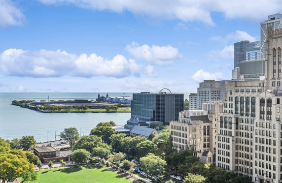 Panoramic view of cityscape with buildings and waterfront area.