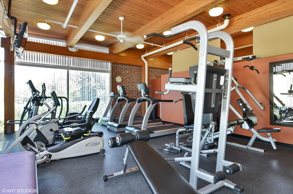 Indoor gym area with exercise equipment and treadmills.