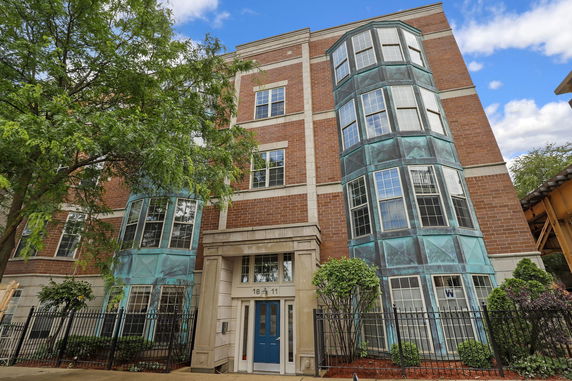Front view of a multi-story building with brick and teal accents.
