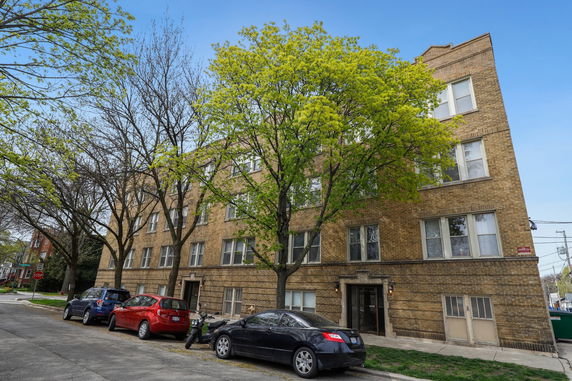 Front view of a multi-story brick apartment building.