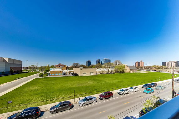 Wide angle view of an urban park with buildings in the background.