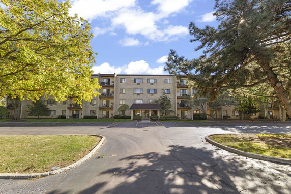 Front view of a multi-story residential building with balconies.