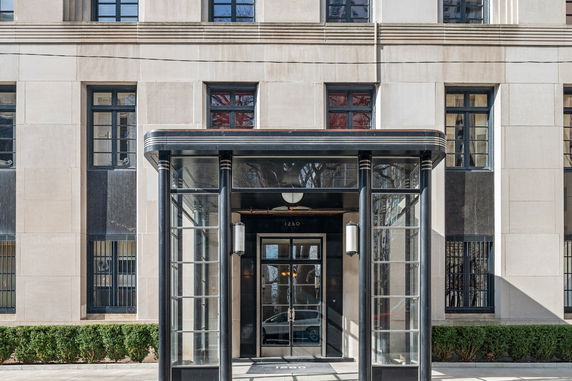 Front view of a building with a glass and metal entrance.